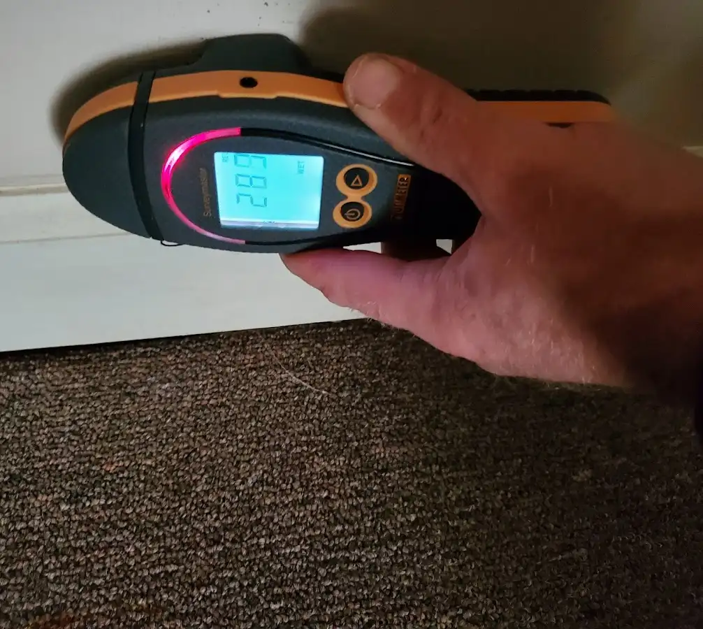 Moisture detection at baseboard during Storm Damage Restoration in Falls Church